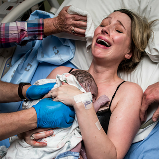 Woman with new born baby after childbirth